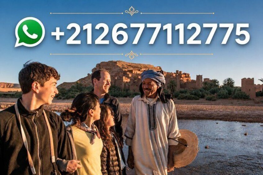 A group of people standing by a river with a historic building in the background. 1