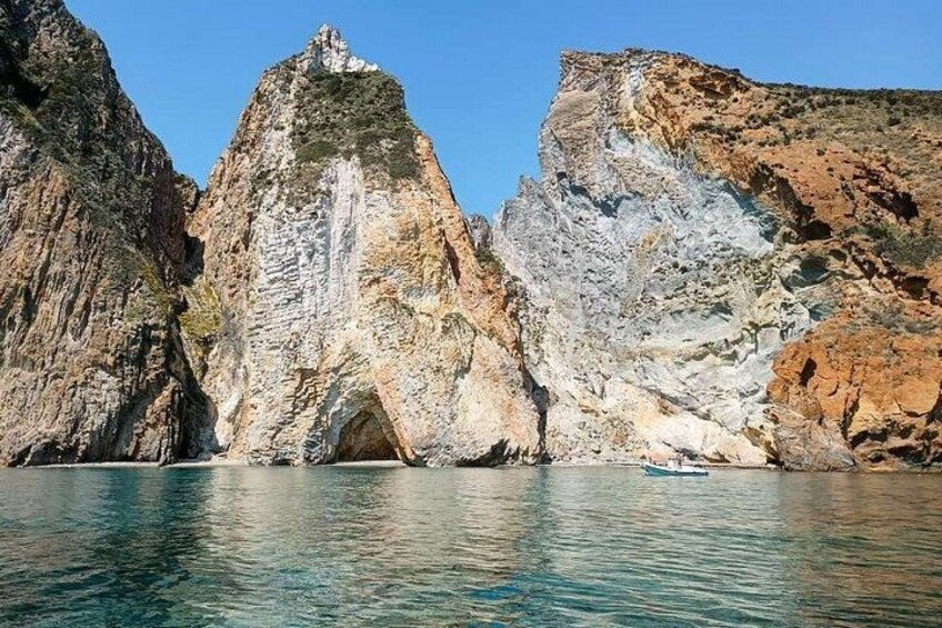 A rocky coastline with a prominent cave entrance. 2