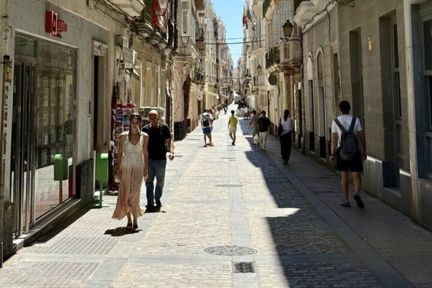 A cobblestone street lined with shops and buildings. 3