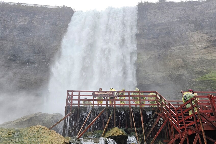 A waterfall with a sign reading 'Hurricane Canyon of the Winds.' 2