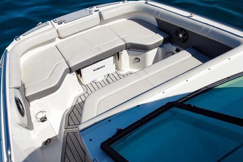 A boat's interior with a white color scheme and a logo on the backrest. 4