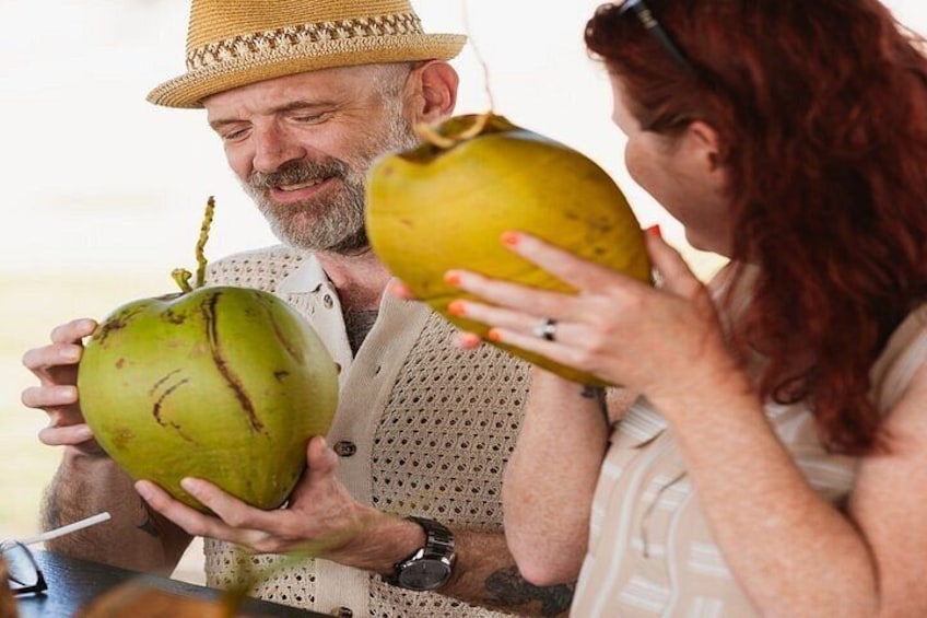 Two people holding coconuts. 3
