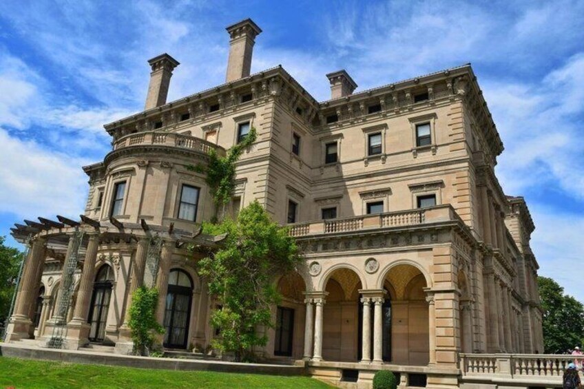 A large, historic building with classical architecture, featuring columns, arched windows, and a symmetrical facade. 5