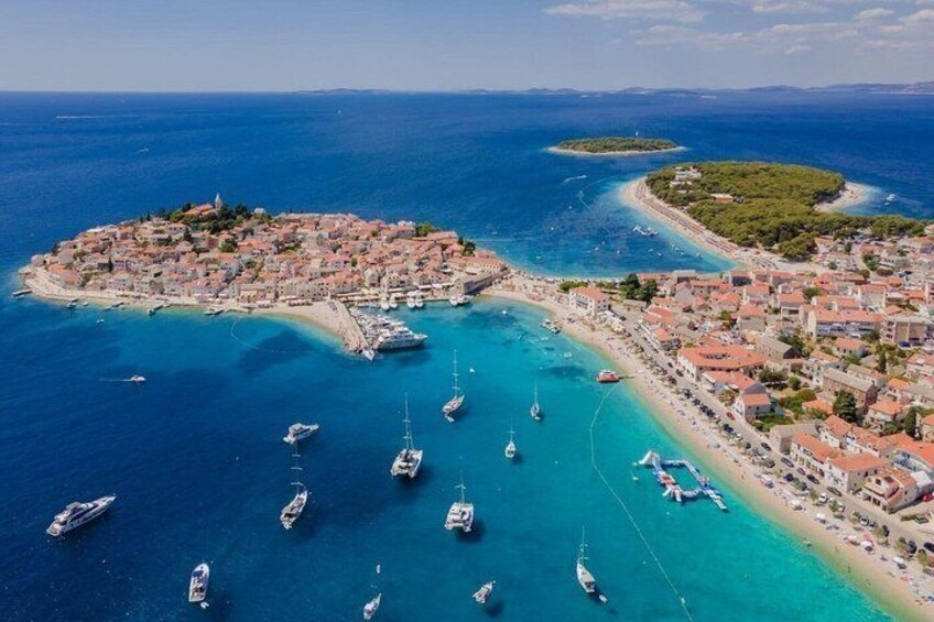 A coastal town with a harbor, boats, and a small island. 2