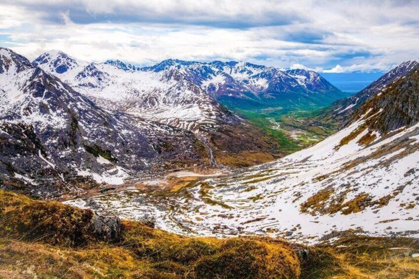 A mountainous landscape with snow-covered peaks and a valley. 4