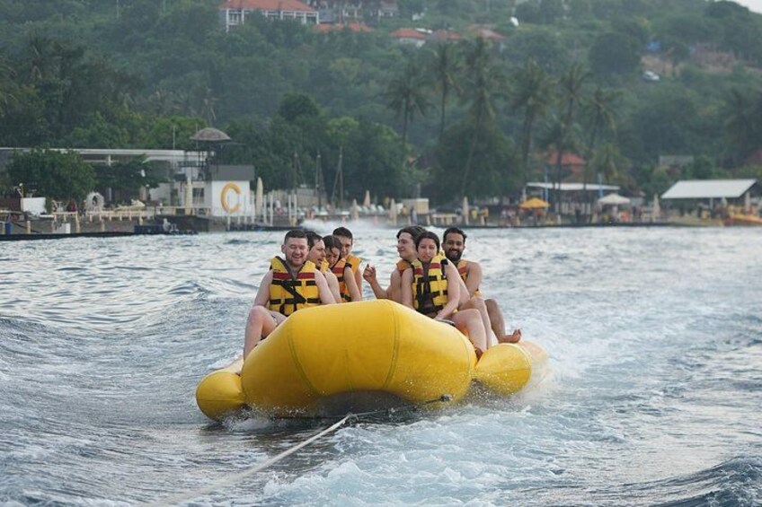 People riding a yellow inflatable raft on water. 3