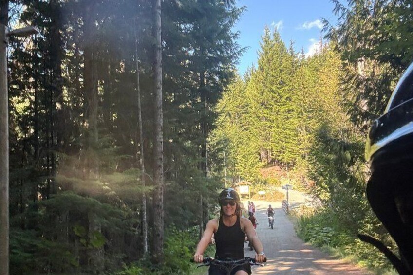 A forested path with cyclists. 2