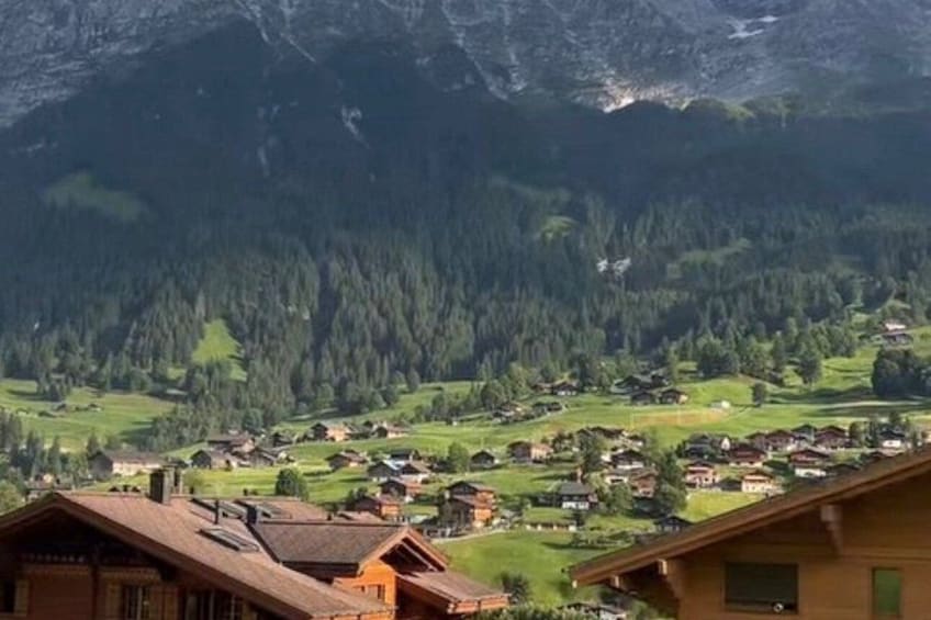 A mountainous landscape with a village nestled in the valley. 2