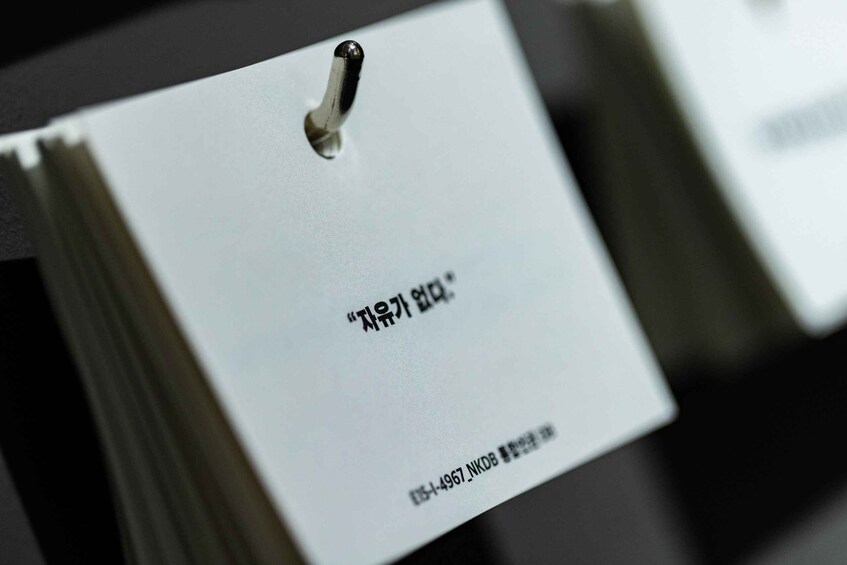 A close-up of a white tag with Korean text and a barcode. 4