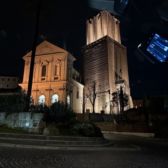 A historic building with a bell tower at night. 3