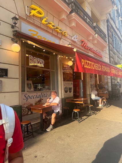 Un restaurant de pizzas avec une terrasse et une enseigne indiquant « Pizzas et mortadelle ». 5