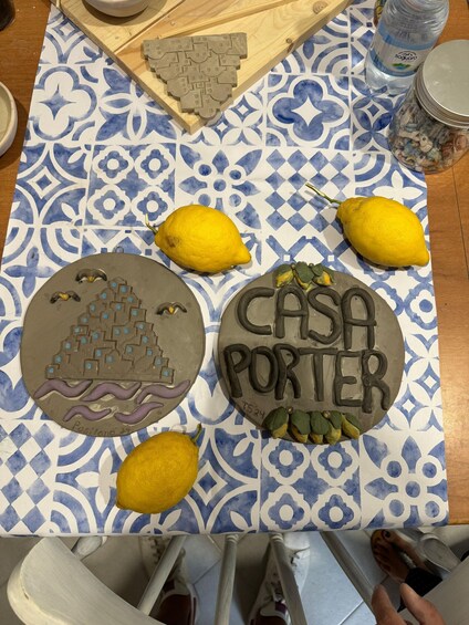 A table with decorative cakes, lemons, and a water bottle. 2