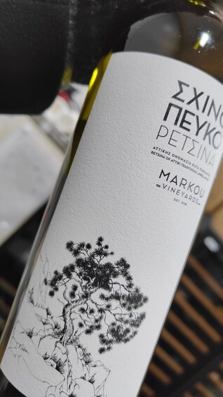 A bottle with a label featuring a tree illustration and text in Greek. 3