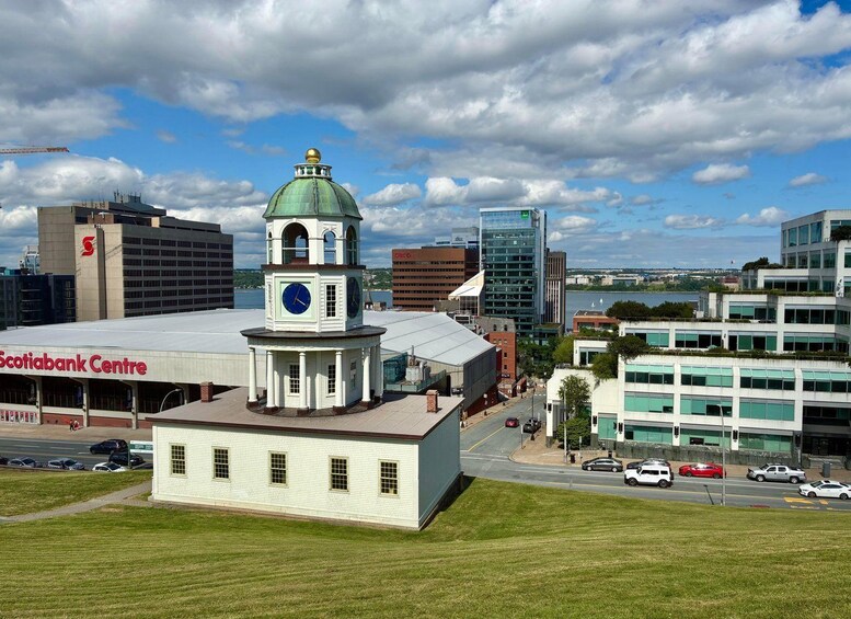 A cityscape with a prominent clock tower, a Scotiabank Centre, and modern buildings. 3