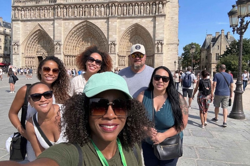 A group of people in front of a historic cathedral with Gothic architecture. 3