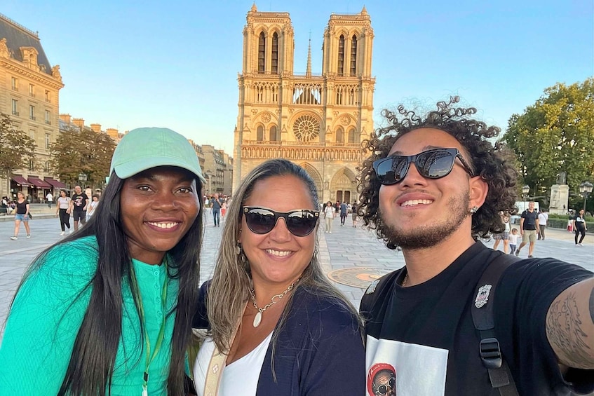 Three people in front of Notre-Dame Cathedral. 1