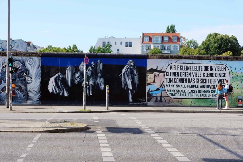 A mural on a wall with a traffic light and a pedestrian crossing. 4