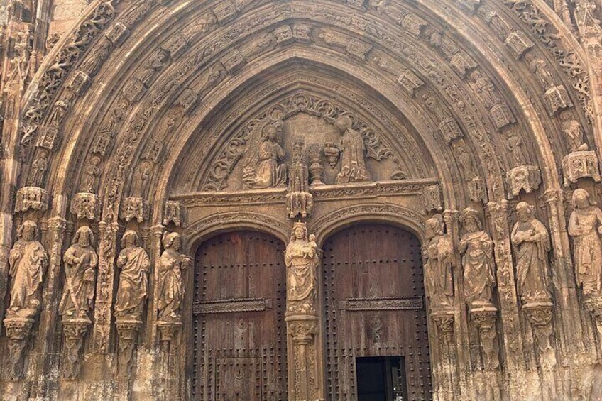 A Gothic cathedral entrance with intricate carvings and statues. 3