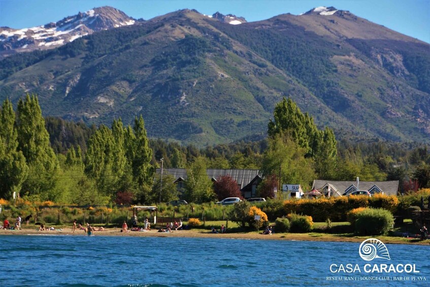 A mountain landscape with a beach and a building labeled 'CASA CARACOL.' 4