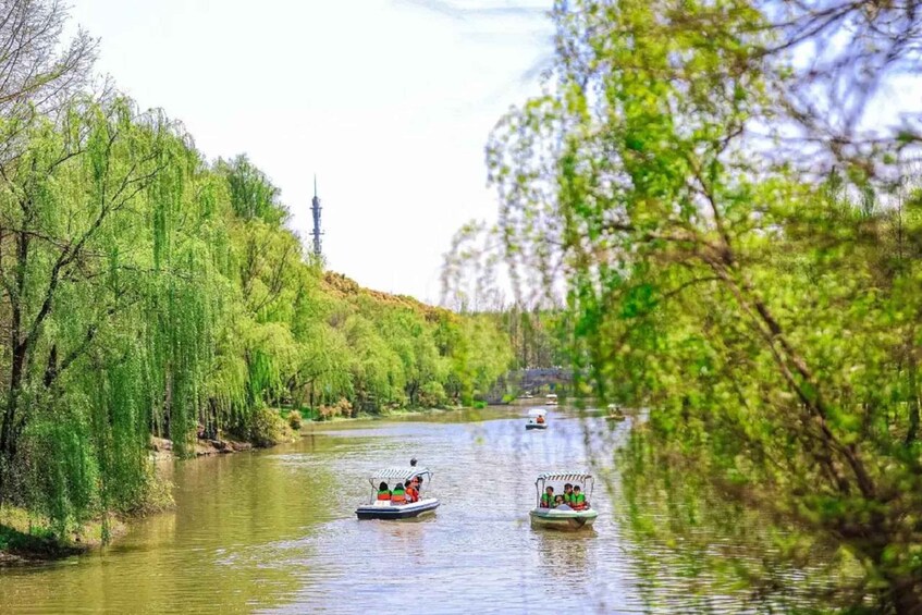 Two boats on a river surrounded by trees. 2