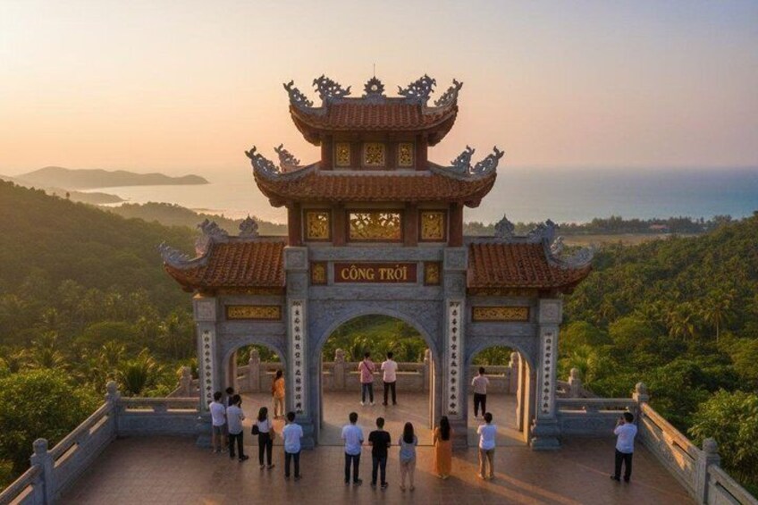 A traditional gate with 'CÔNG TRƯỜI' inscribed, overlooking a lush landscape with a distant view of the sea. 4