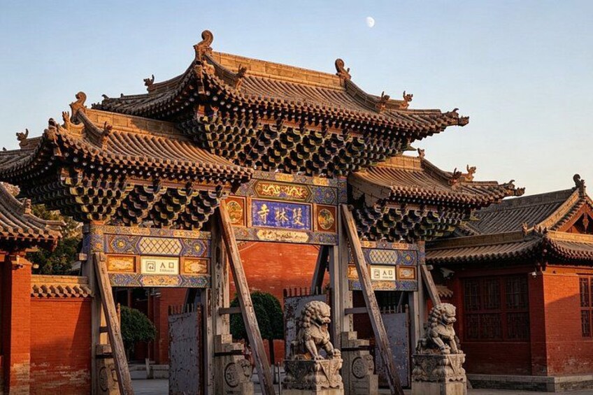 Traditional Chinese architecture with ornate roofs and lion statues. 3