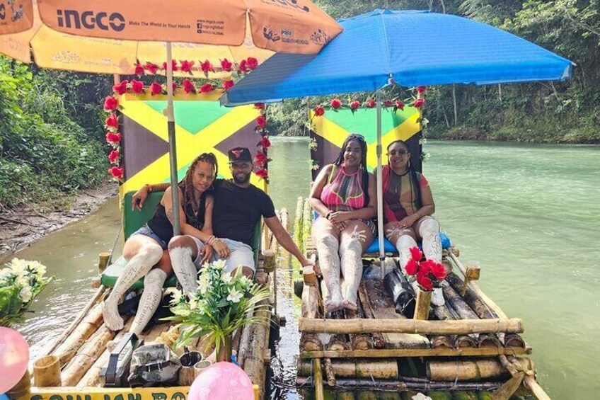 A wooden boat with passengers, decorated with flowers and a blue umbrella. 3