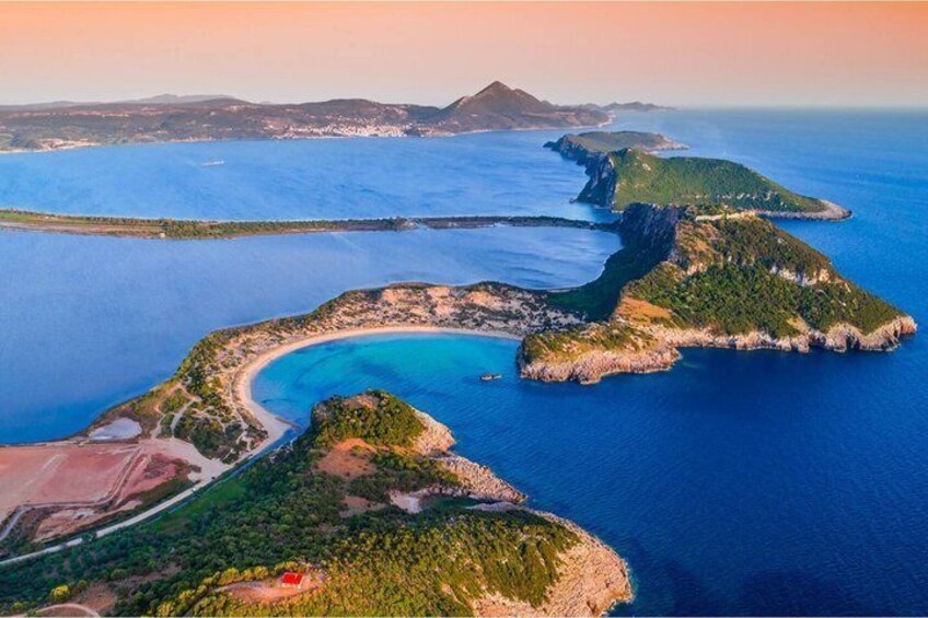 An aerial view of a coastal landscape with multiple islands, clear blue waters, and a mix of green vegetation and rocky terrain. 2