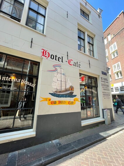 A building with a sign that reads "Hotel Cafe" and "Old Dutch Cafe" with a ship illustration. 3