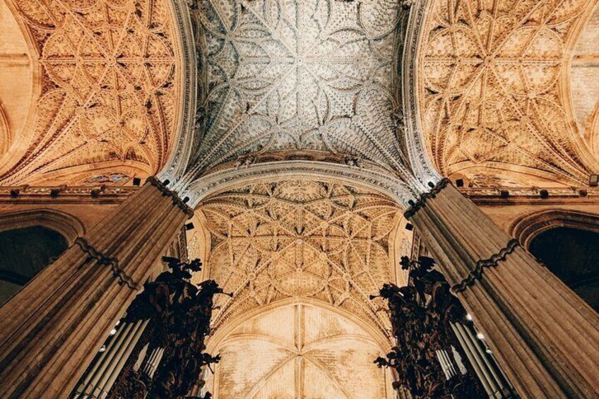 A grand architectural ceiling with intricate patterns and columns. 3