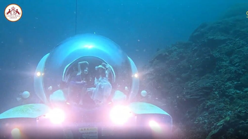 A submarine with a crew inside, surrounded by underwater terrain. 1