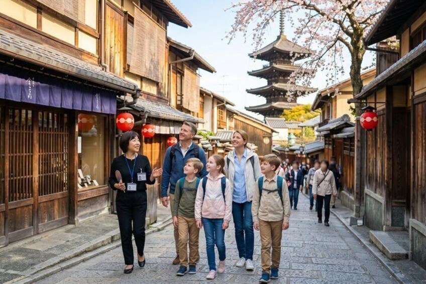 A group of people walking on a traditional street with wooden buildings and a pagoda in the background. 1