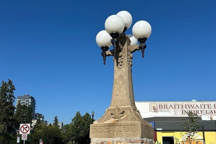 A stone monument with a plaque reading 'THE CARNEAU' and a sign for 'BRAITHWAITE INN' in the background. 2