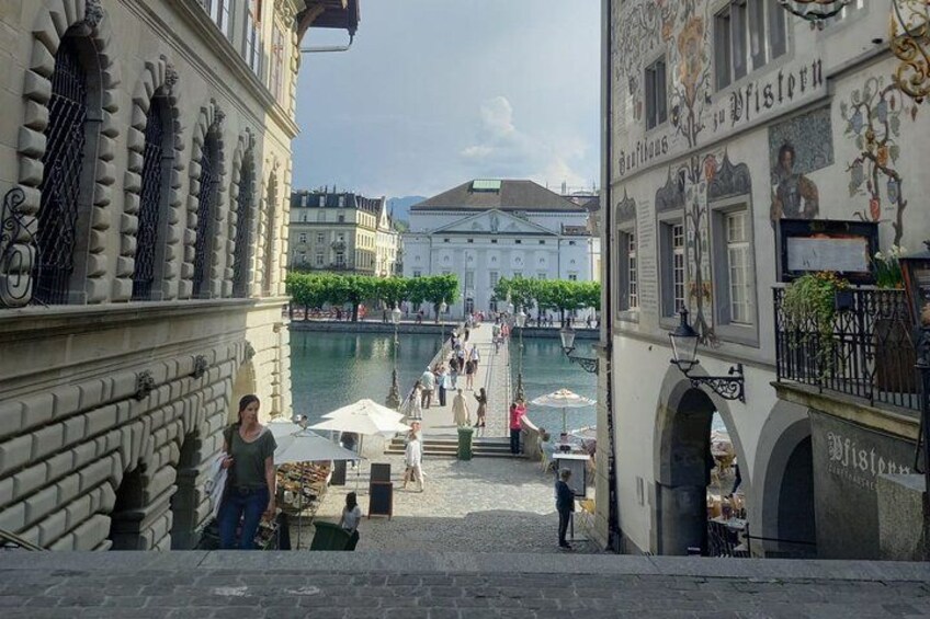 A canal with boats, a market, and historic buildings. 2