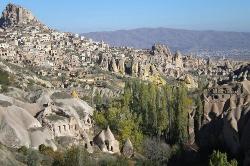 A town nestled among unique rock formations. 5