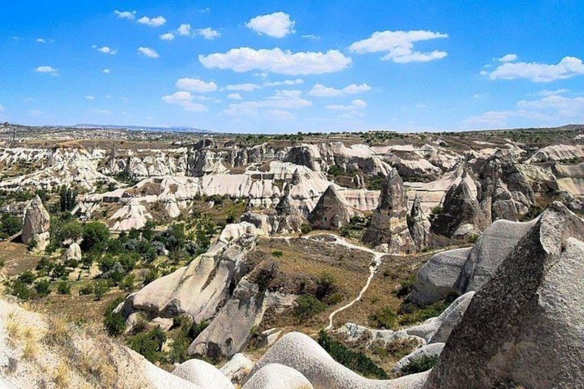 A landscape with numerous rock formations and a clear sky. 4