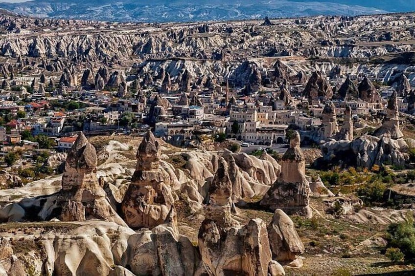 A landscape with prominent rock formations and a town in the background. 3