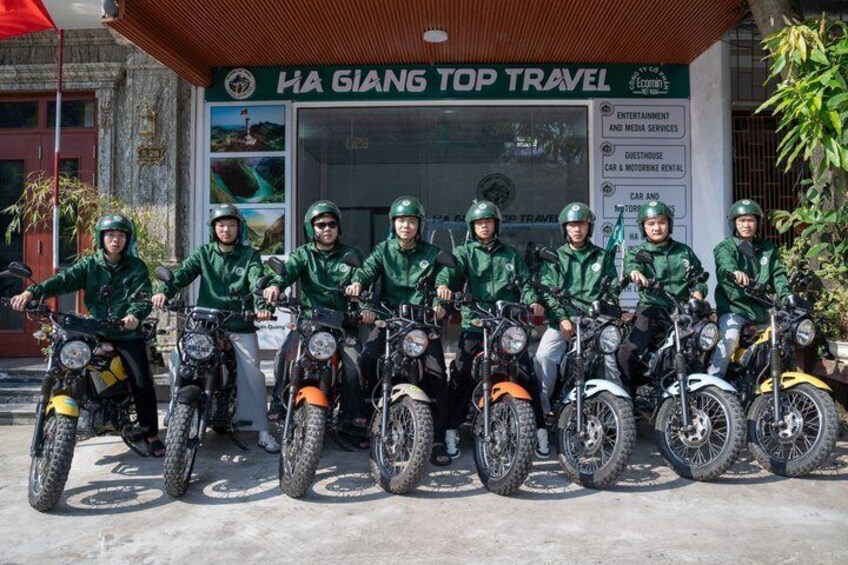A group of people on motorcycles in front of a travel agency. 2