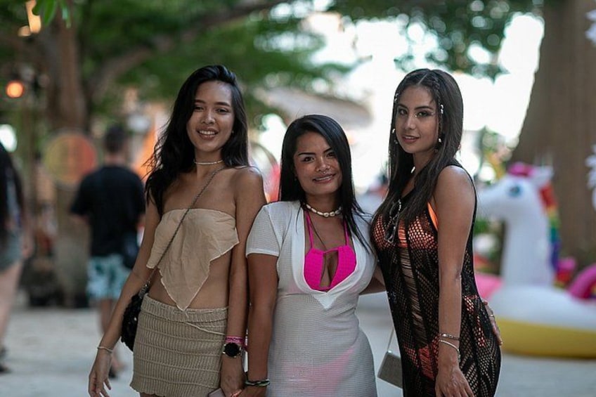 Three people standing outdoors, possibly at a public event or gathering. 4