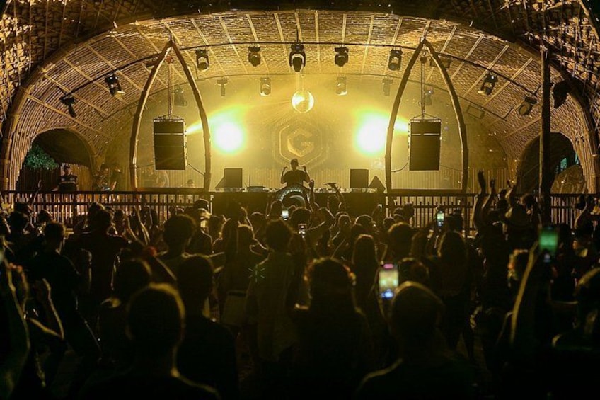 A concert with a crowd, stage, and a large circular roof structure. 5