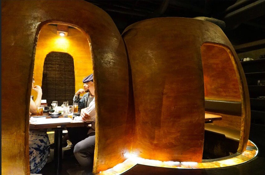 A restaurant with arched booths and a warm, illuminated interior. 4