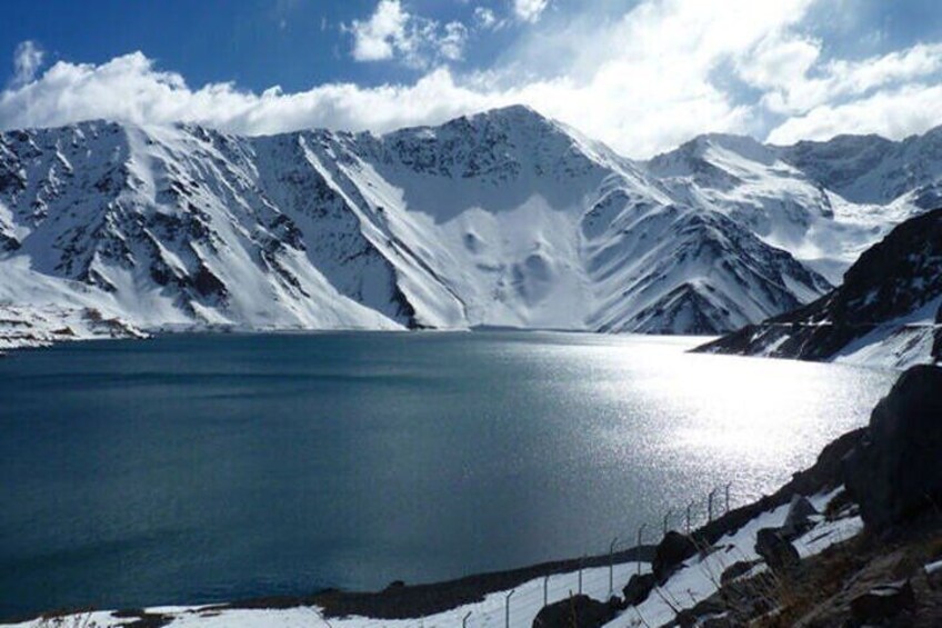 A snow-covered mountain range with a lake. 1
