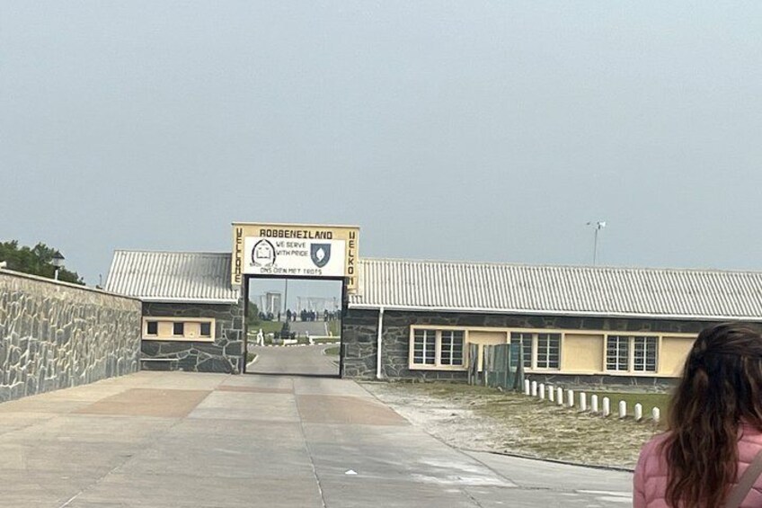 A building with a sign reading 'Robben Island' and a view of the entrance. 5