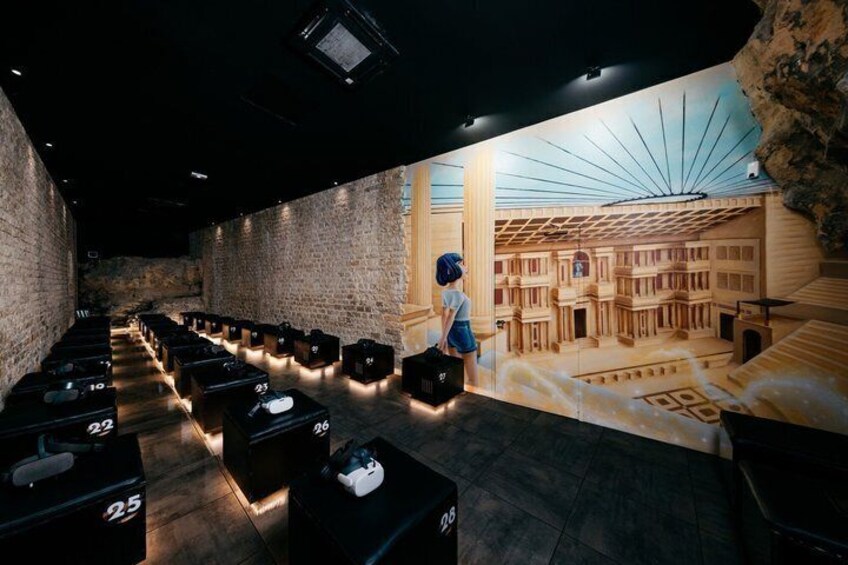 An indoor exhibition with rows of display cases and a model building. 2