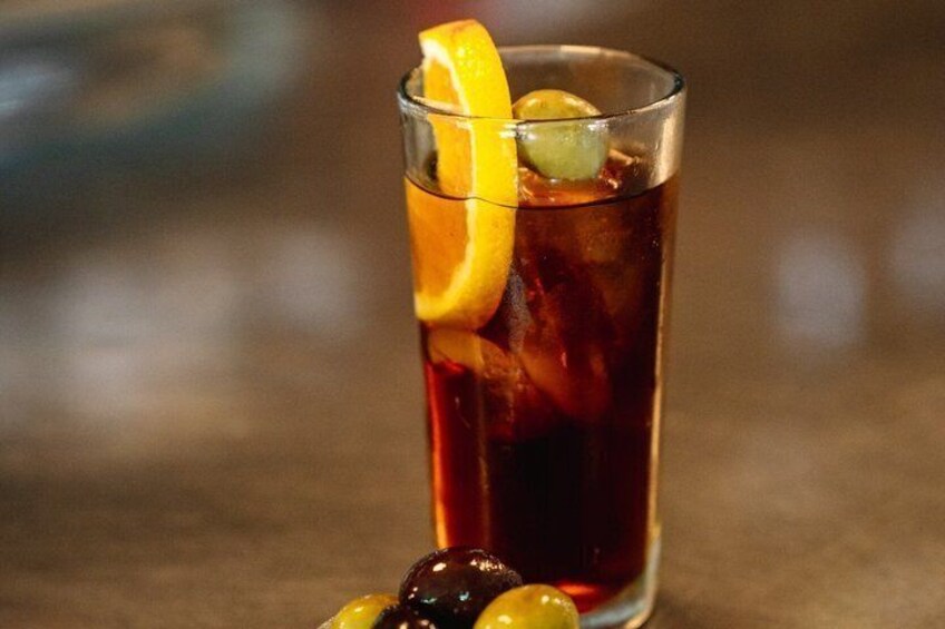 A glass of iced tea with a lemon slice and a cherry. 4