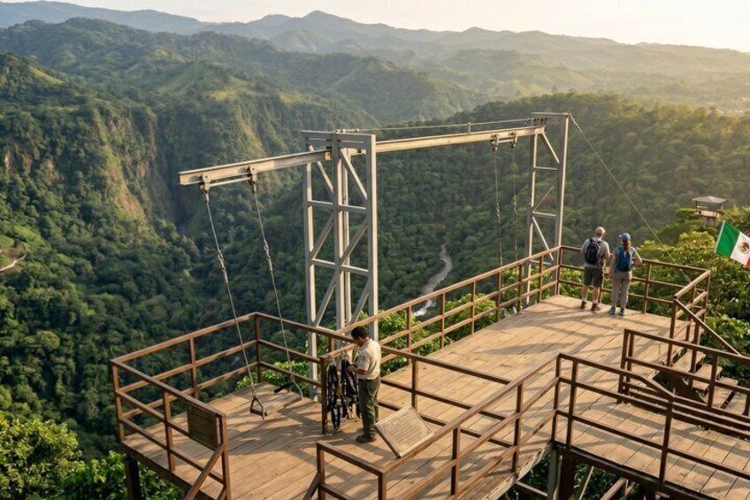 A wooden observation platform with metal railings overlooking a mountainous landscape. 2