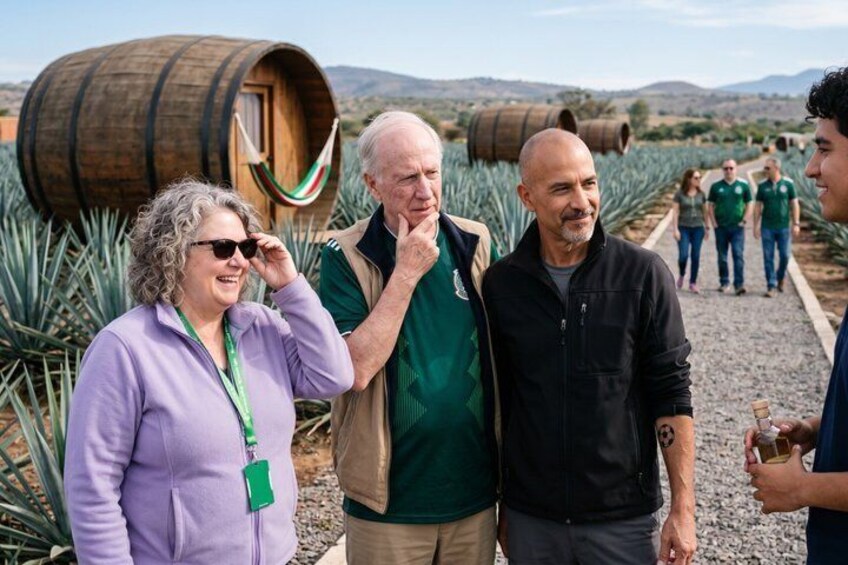 A group of people standing in a vineyard with rows of grapevines and wooden barrels in the background. 5