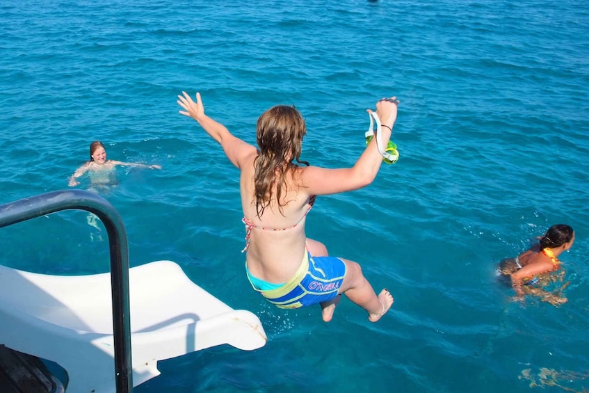 A person jumping from a boat into the water. 3