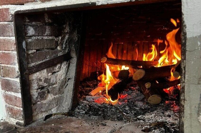 A fireplace with burning logs and flames. 4
