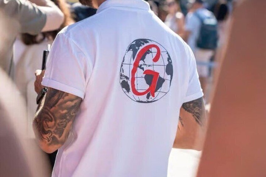 A person wearing a white t-shirt with a red and black logo on the back. 3
